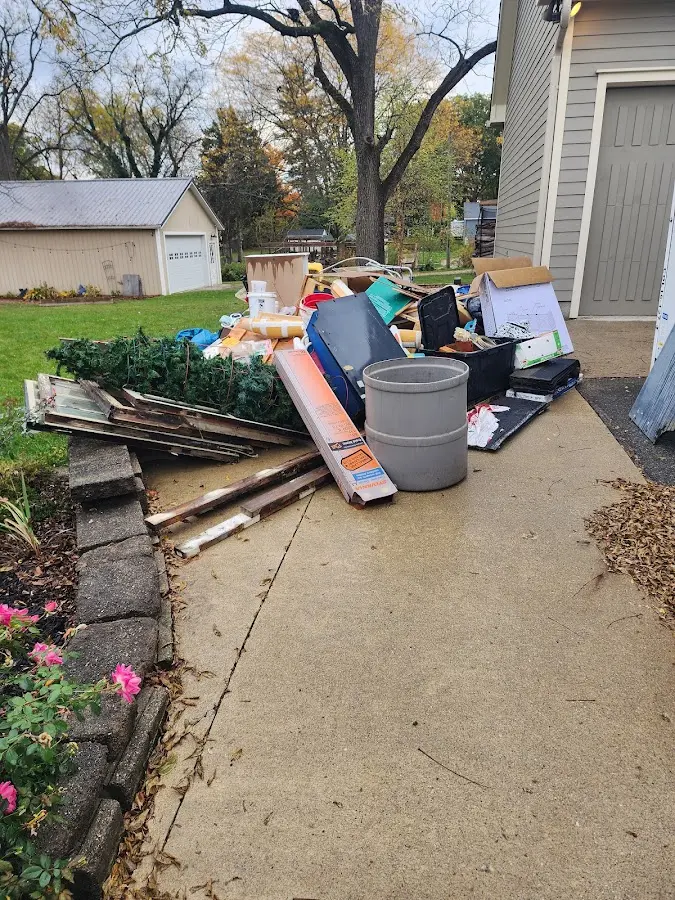 Dumpster being loaded with debris for Estate Cleanout Dumpster Rental in Eldon